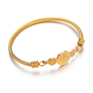 Gold cable twist open bangle with Saint Benedict Medal and cross charms in stainless steel
