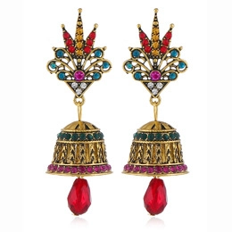 Detail of vintage gold Jhumka earrings with multicolor rhinestones and red teardrop bead