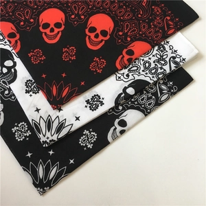 Detail of cotton skull paisley bandanas in red, black and white folded in stacks
