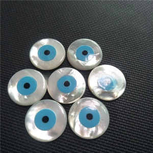 Close-up of white mother of pearl evil eye beads for DIY jewelry making and crafts