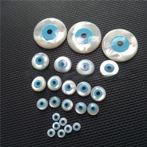 Macro detail of natural mother of pearl evil eye shell beads for jewelry DIY making