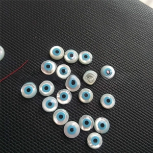 Macro detail of natural mother of pearl evil eye beads for DIY jewelry making