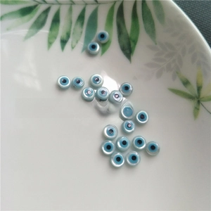 Macro detail of flat round evil eye shell beads for DIY jewelry making accessories