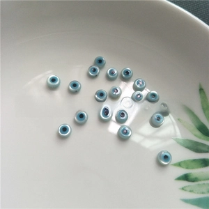 Macro detail of blue evil eye mother of pearl shell beads for DIY jewelry making
