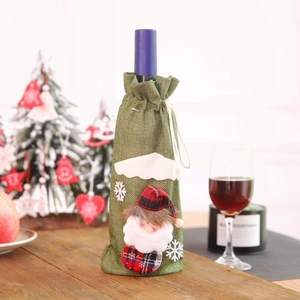 Christmas Santa burlap wine bottle cover with drawstring and snowflake decor on wooden table