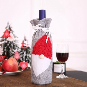 Christmas felt wine bottle cover with embroidery on a festive wooden table setting