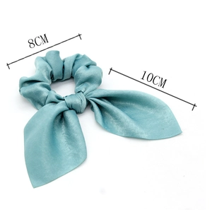Detail of blue satin silk scrunchie with rabbit ear bow showing 8cm and 10cm dimensions