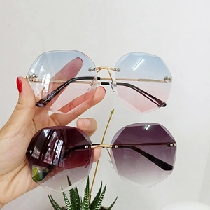 Detail view of rimless octagonal sunglasses with gradient blue-pink and purple lenses