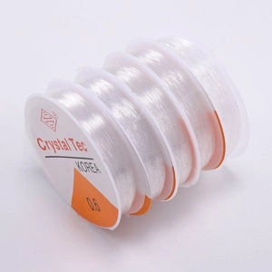 Close-up of five rolls of 0.6mm transparent elastic crystal string for DIY jewelry making