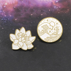 Detailed view of enamel pins featuring Ukiyo-e style waves and white lotus flower