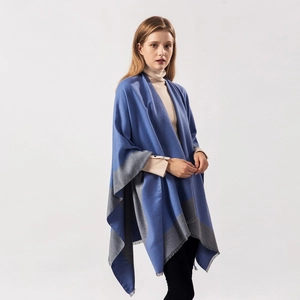 Detail of blue and gray dual-tone shawl with fringe edges and soft warm texture
