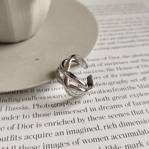 Macro view of interwoven 925 sterling silver ring layers with S925 engraved stamp