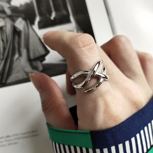 Macro detail of polished 925 silver braided ring with modern multi-layer woven design