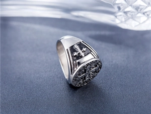Macro shot of silver vintage gothic ring showing St. Benedict medal and cross engraving