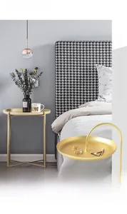 Detailansicht der doppelstöckigen goldenen Metallablage mit elegantem Griff und Mattlack