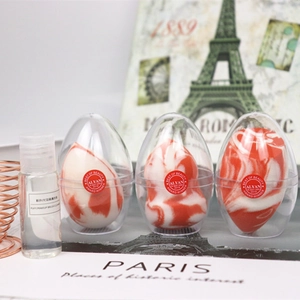 Detail of marble pattern makeup sponges with capsule cases and brush cleanser fluid