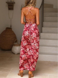 Detail of the backless floral maxi dress featuring a cross bandage strap design