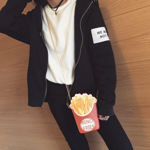 Red French fries shaped crossbody bag with a gold chain strap worn by a model
