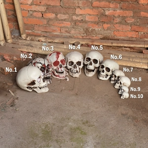 Set of 10 realistic Halloween skeleton skulls with glowing features for spooky decor
