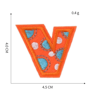 Orange embroidered letter V patch with blue dots and precise 4.5cm x 4.0cm dimensions