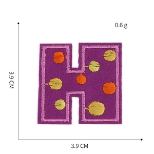 Detailed embroidery patch with purple base and yellow dots showing size 3.9cm measurement