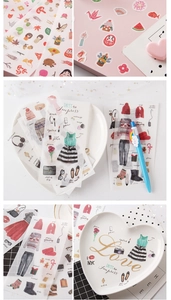 Detail view of cute transparent stickers used on a heart-shaped plate and notebook