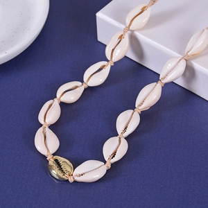 Handmade shell necklace with gold alloy shell pendant on a blue background