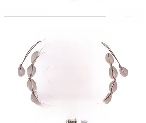 Detail of adjustable natural cowrie shell choker with a gold-plated center shell