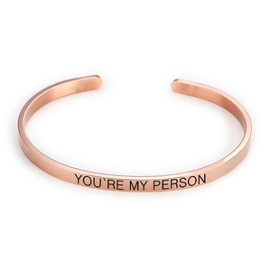 Close-up of polished rose gold titanium steel cuff with YOU'RE MY PERSON engraving