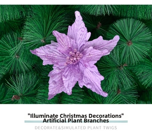 Detail of purple glitter poinsettia artificial flower on green Christmas tree branches