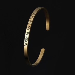 Gold plated titanium steel cuff bracelet with You're My Person engraving and satin finish