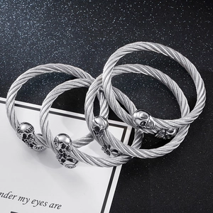 Three men's stainless steel wire cable bangles with skull heads in punk rock style