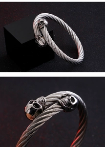 Detail view of a men's skull steel wire cable cuff bracelet with punk biker style