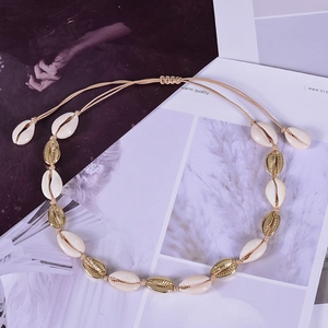 Bohemian gold seashell necklace with woven cord and adjustable strap for beach styling
