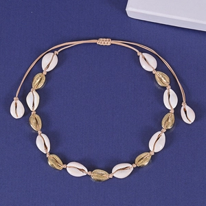 Bohemian gold shell necklace with white natural shells on woven adjustable cord