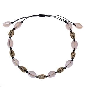 Detail of bohemian shell necklace with gold alloy accents and woven adjustable cord