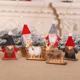 Close-up of wooden Christmas gnome and reindeer figurines with warm festive lighting