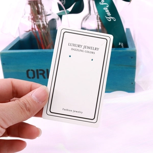 Close-up of white jewelry display card featuring elegant Luxury Jewelry lettering