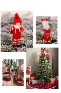 Close-up of knitted ski dolls and festive scene with a decorated Christmas tree