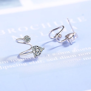 Elegant silver heart-shaped stud earrings with sparkling cubic zirconia on light background
