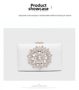Detail of white evening clutch featuring a large rhinestone sunflower and gold clasp