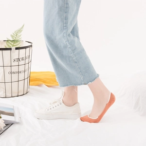 Orange low-cut invisible cotton socks for women paired with sneakers for summer wear