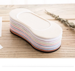 Close-up of colorful cotton invisible boat socks with anti-slip silicone on wood surface