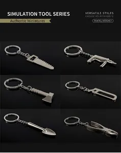 Set of six zinc alloy miniature tool keychains including saw, drill, axe, and pliers
