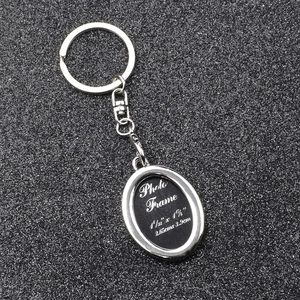 Close-up of silver metal photo frame keychain showing precise 2.65cm x 3.9cm dimensions