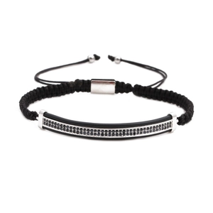 Detail view of woven bracelet with curved silver bar and double row black zircon inlays