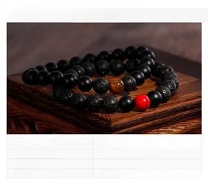 Detail of 8mm bead bracelets featuring lava stone, tiger eye, and red turquoise stones