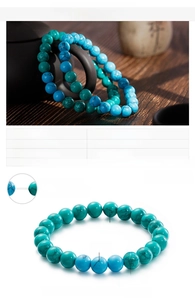 Detail of 8mm turquoise beaded bracelet with blue and green stones on elastic cord