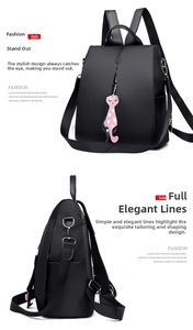 Detail of minimalist black nylon backpack with theft-proof design and pink cat heart charm