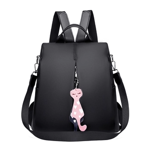 Black nylon casual backpack with pink heart cat keychain charm on white background